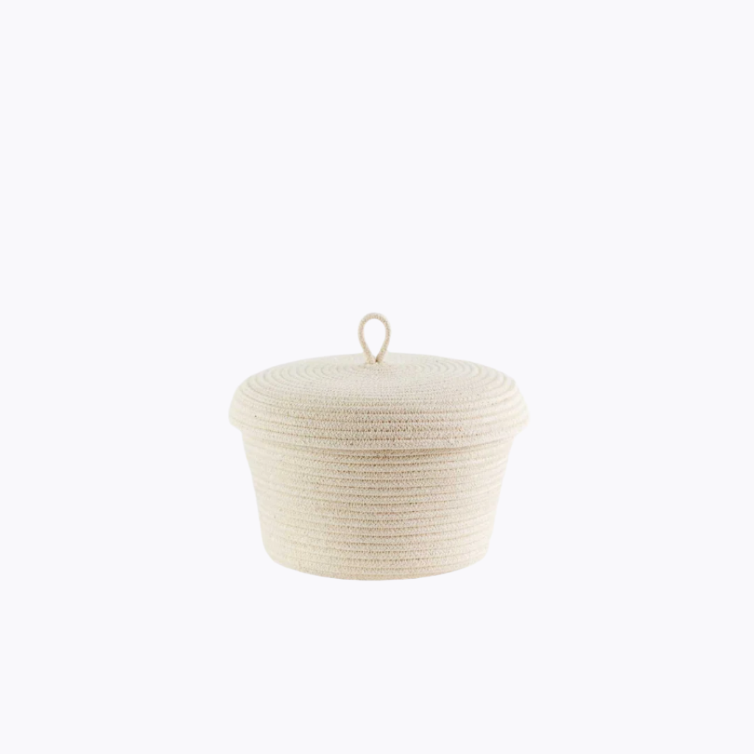 A beige lidded rope basket made from cotton, with a handle on the lid and a coiled design.
