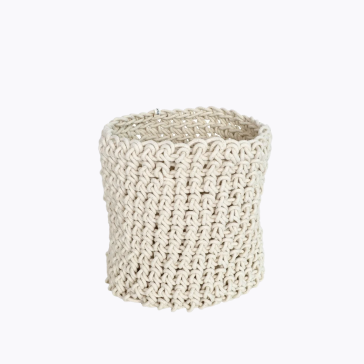 A beige cylindrical rope basket made from cotton, with a textured weave pattern.