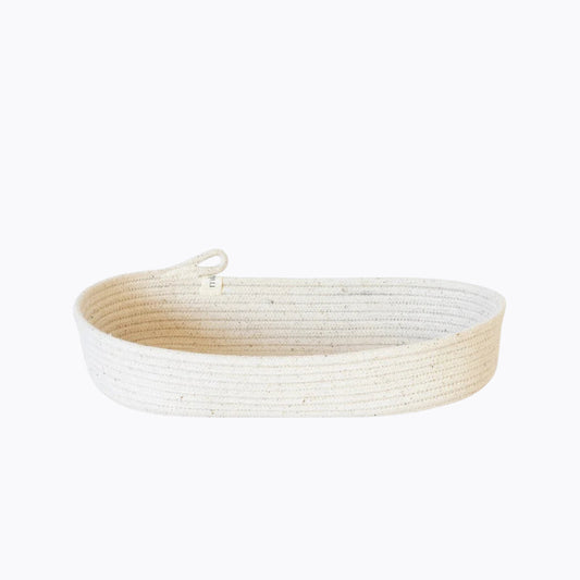 An oval rope basket made from natural cotton, featuring a sturdy handle.