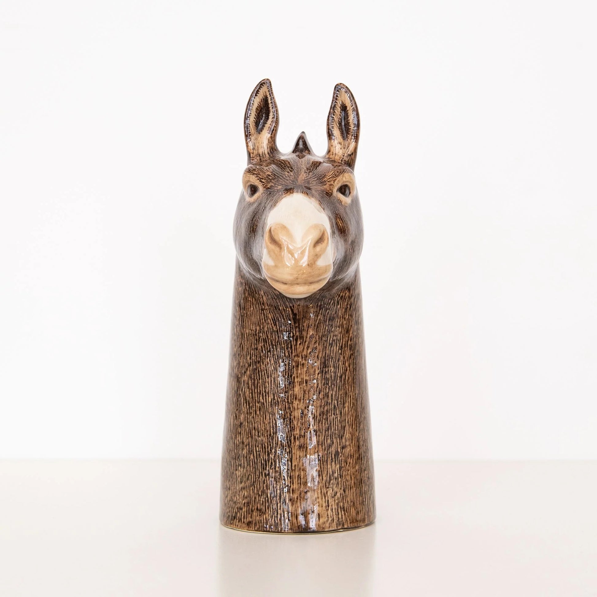 Decorative donkey head vase on a white background