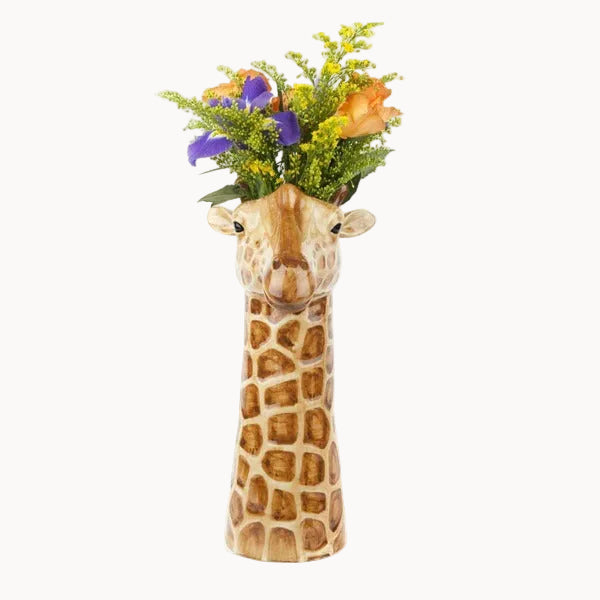 Giraffe-shaped vase with a bouquet of flowers on a white background