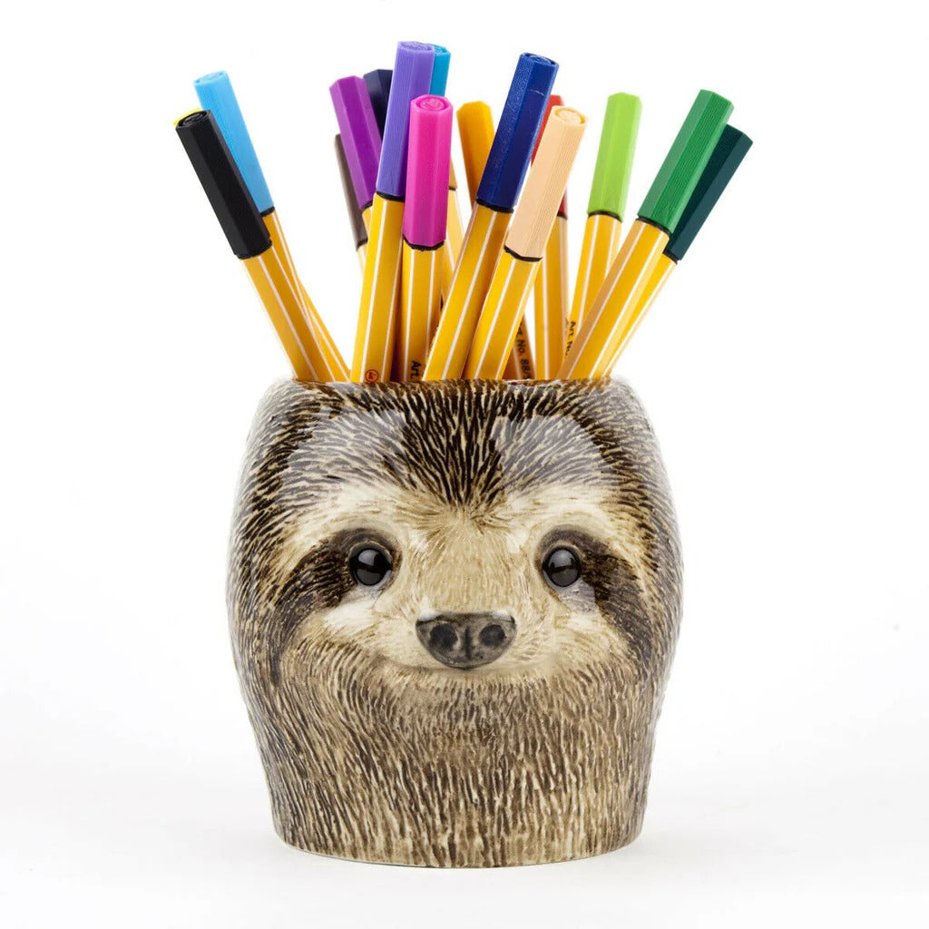 Sloth-shaped pen holder with colorful markers on a white background
