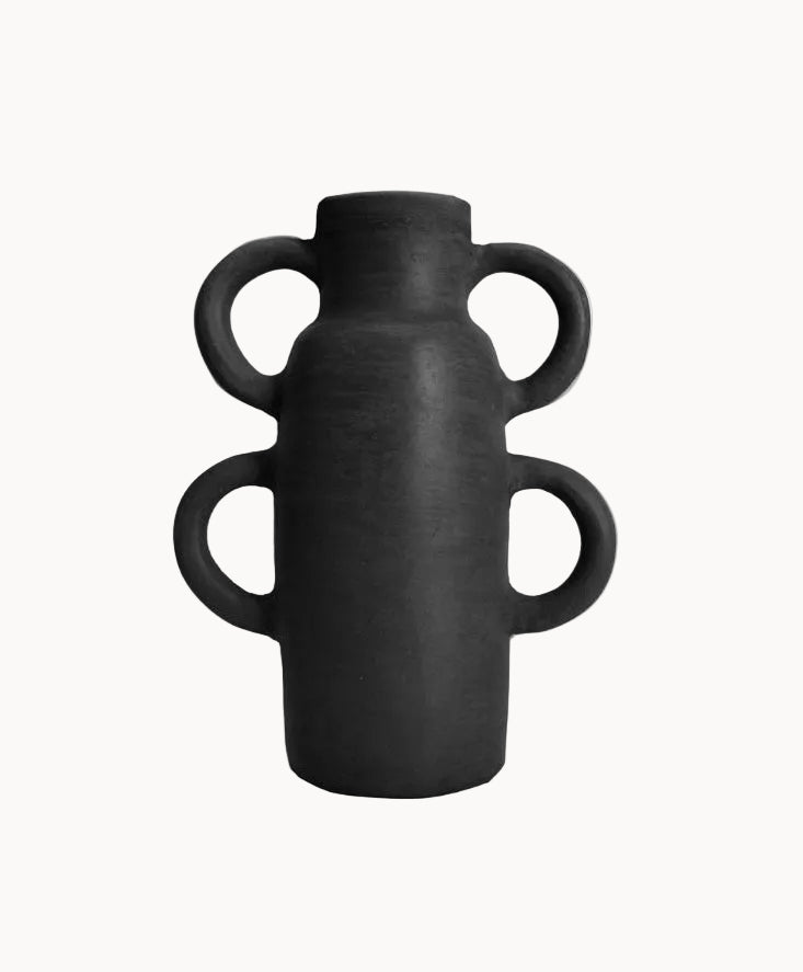 Black ceramic vase with handles on a white background