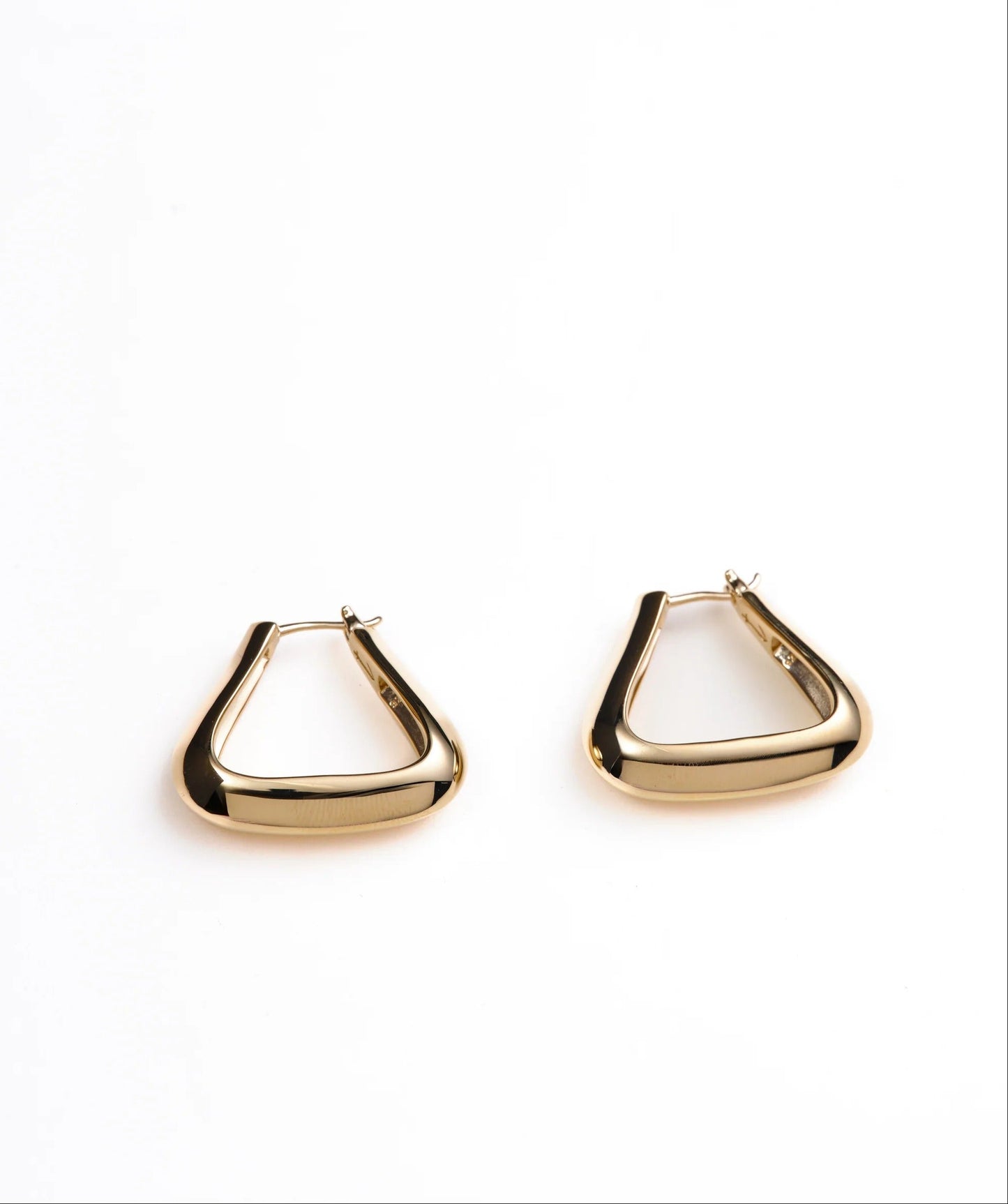 Gold triangle-shaped earrings on a white background