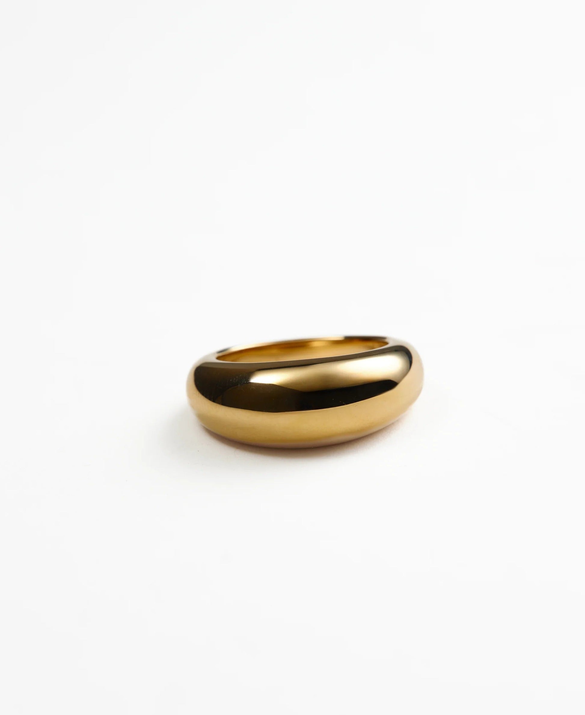 Gold domed ring on a white background