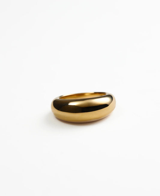 Gold domed ring on a white background