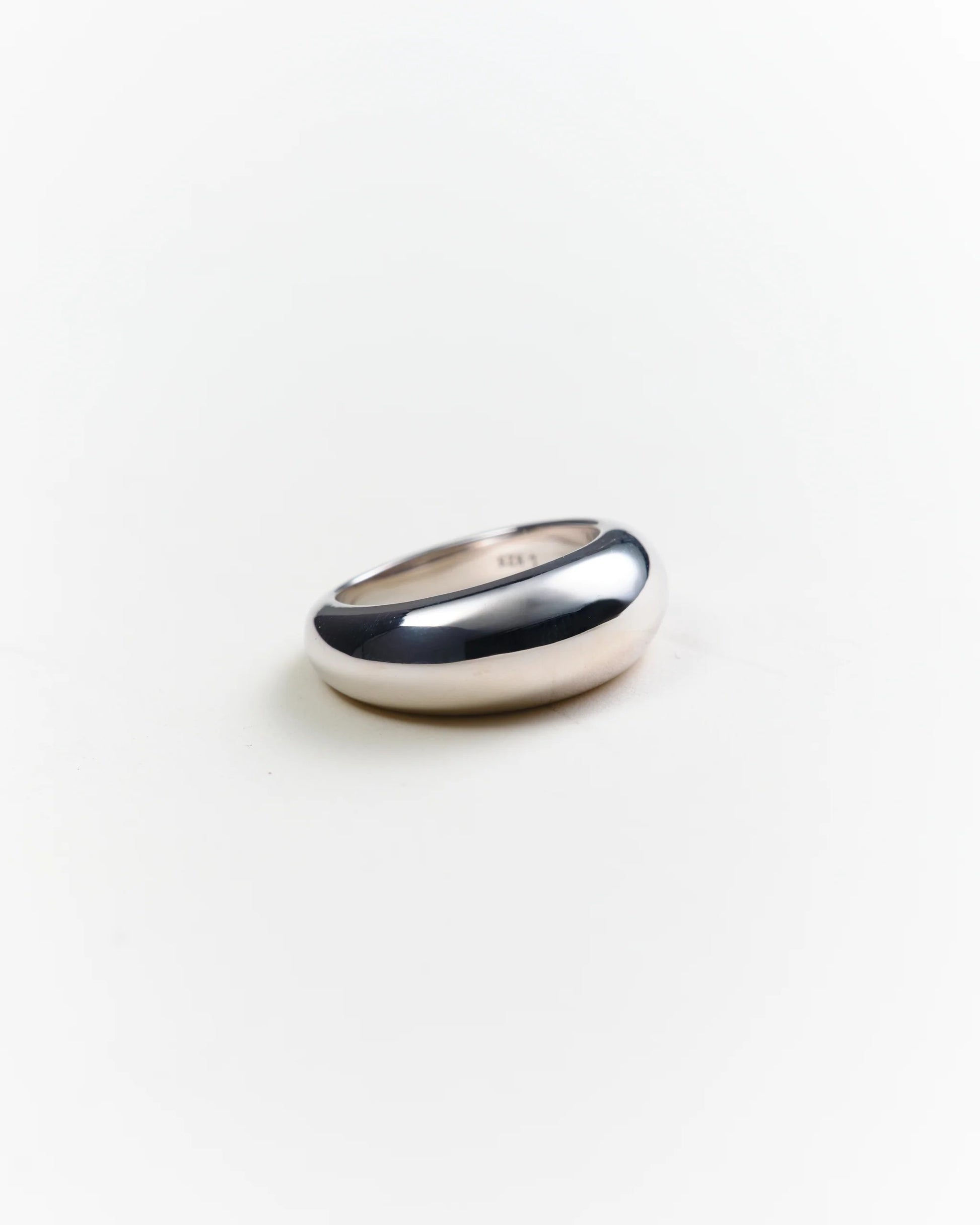 Silver ring on a light gray background