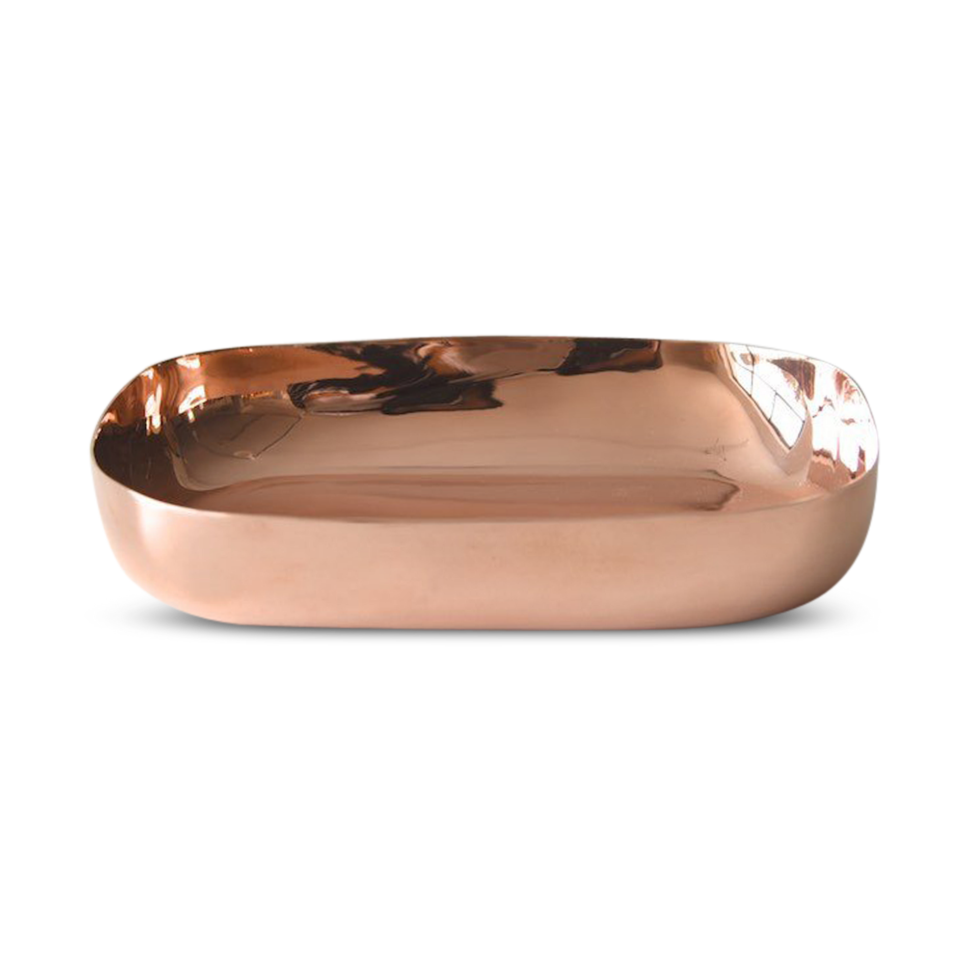A polished copper serving platter with an organic shape, reflecting light on its surface.