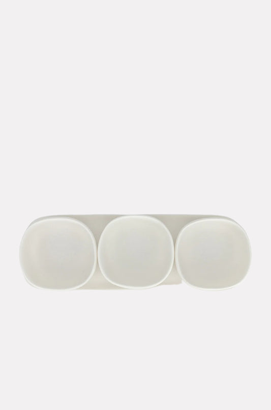 Three white hand-sculpted bowls arranged on a matching oblong tray against a white background.