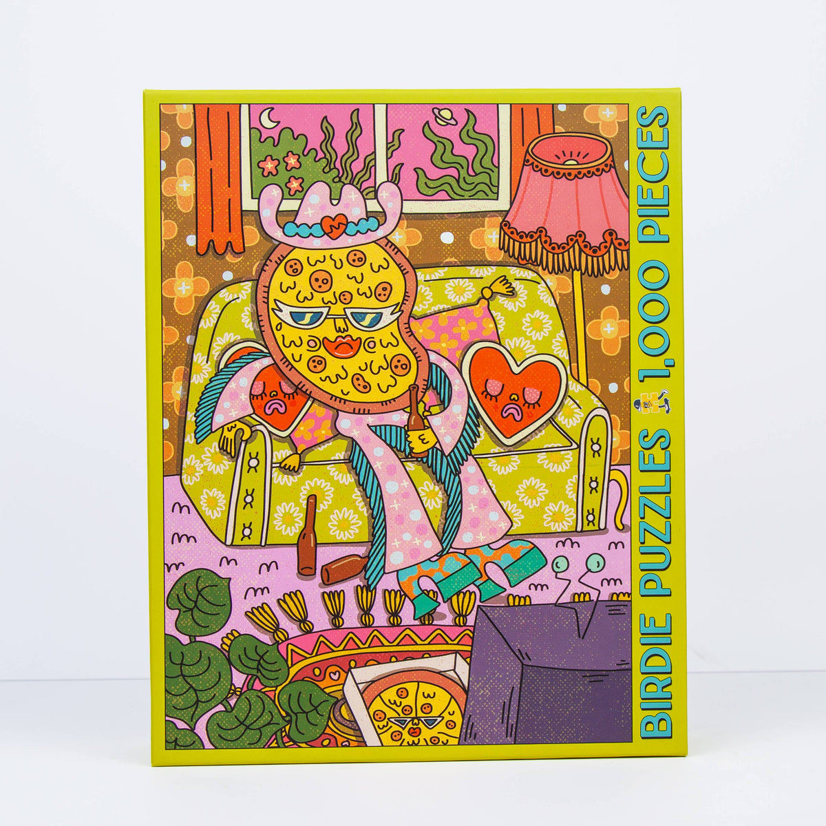 A 1000-piece birdie puzzle box featuring a colorful, psychedelic cartoon illustration of a character sitting on a couch with a heart-shaped pillow. 