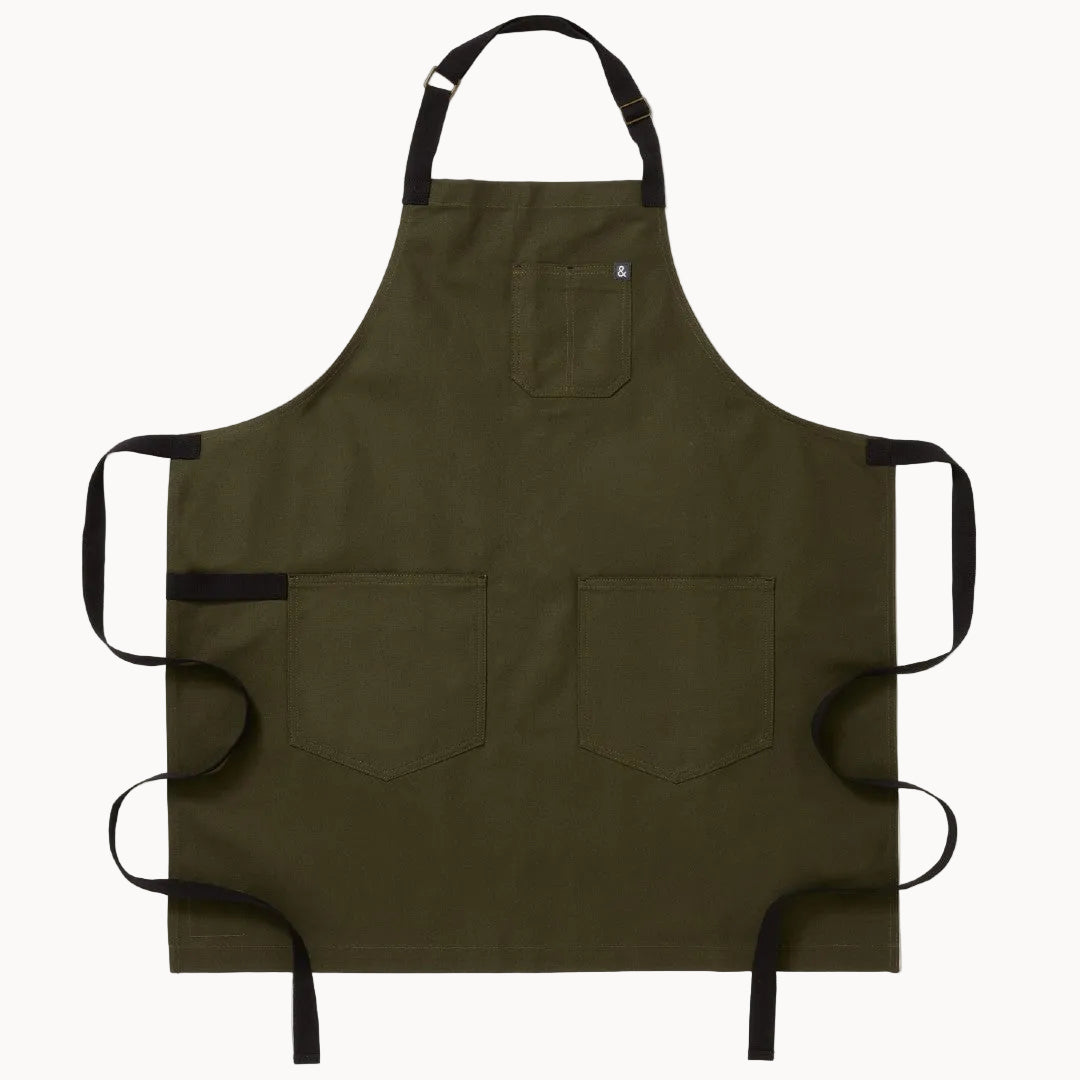 Olive green apron with black straps on a white background