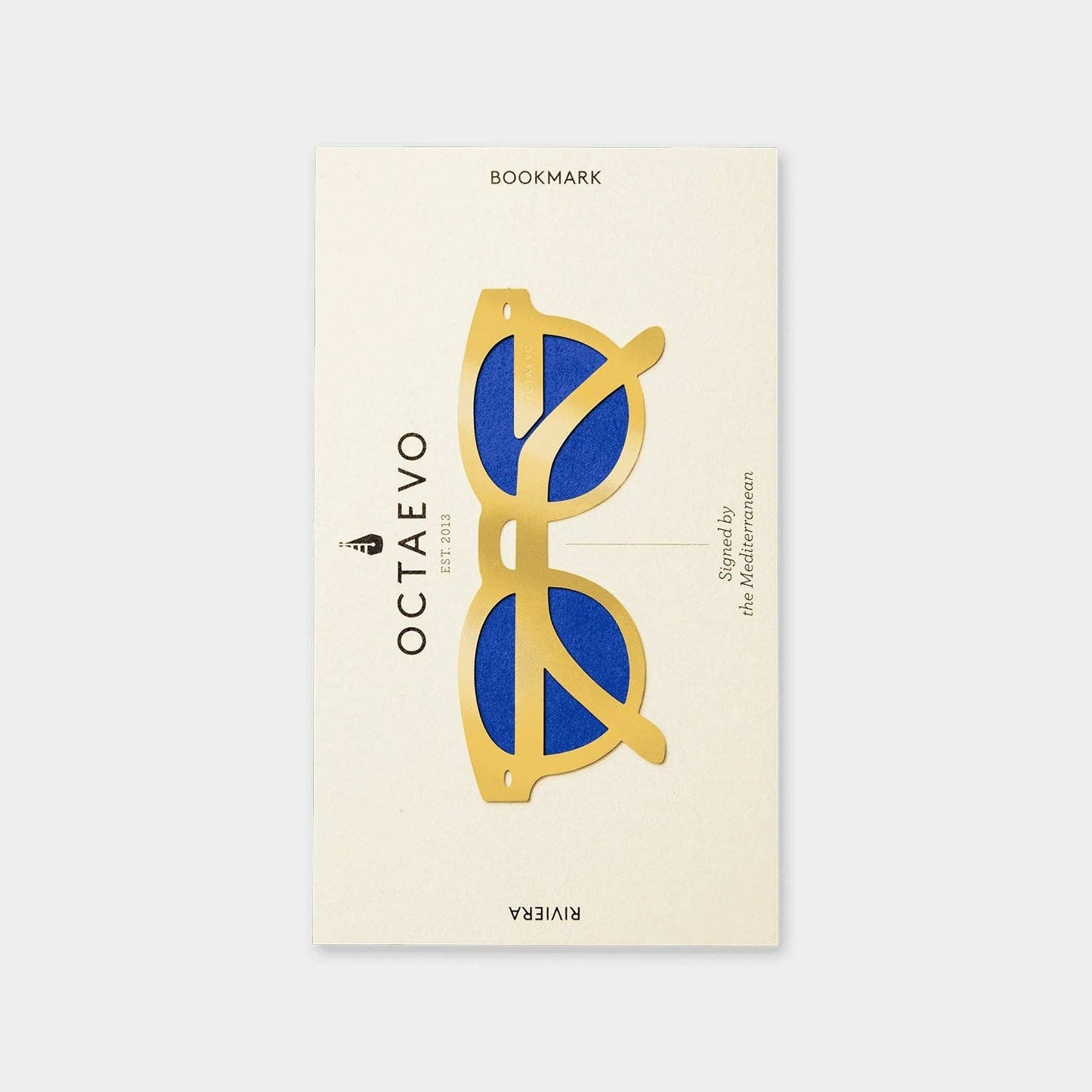 a brass bookmark with a display of blue and gold sunglasses, and a text of 'OCTAEVO'