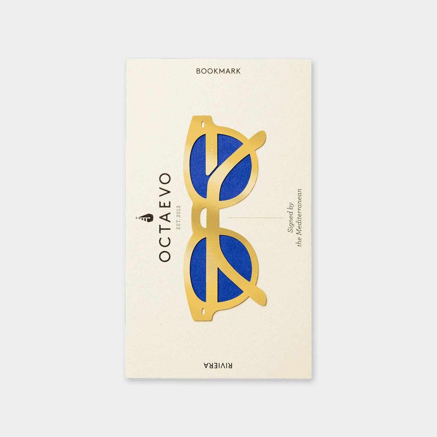 a brass bookmark with a display of blue and gold sunglasses, and a text of 'OCTAEVO'