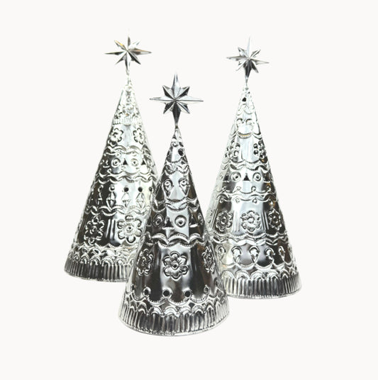 Three tabletop tin Christmas trees with star-topped designs on a white background.