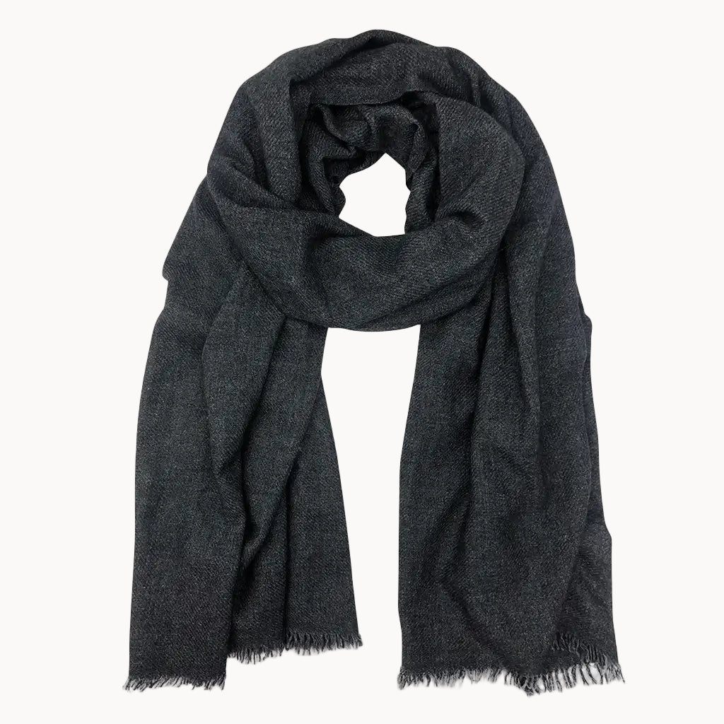 Black cashmere scarf with frayed edges on a white background