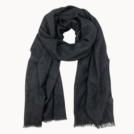 Black cashmere scarf with frayed edges on a white background