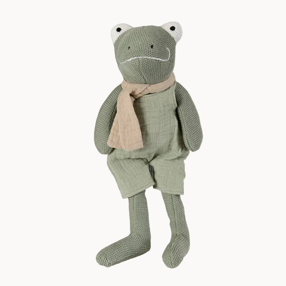 Knitted frog toy with a beige scarf on a white background