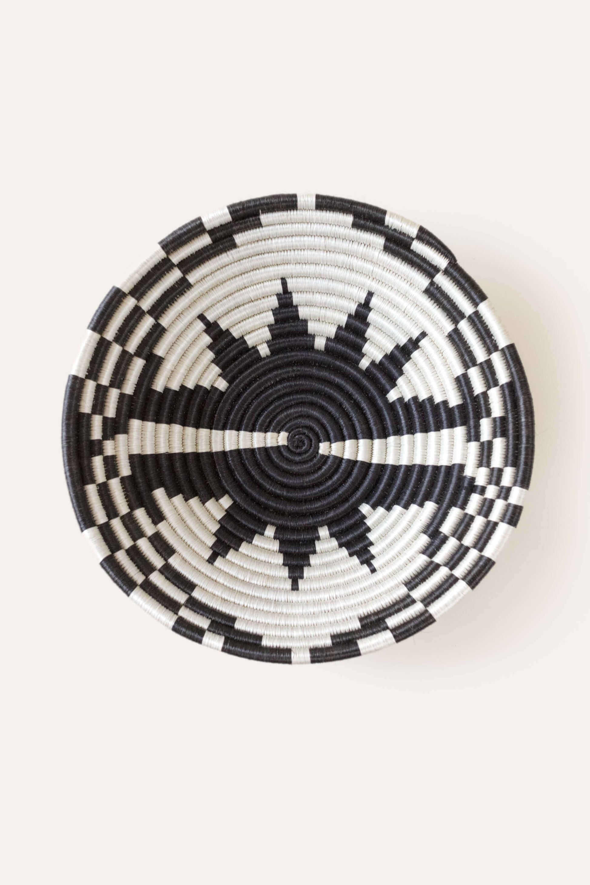Black and white woven basket on a white background