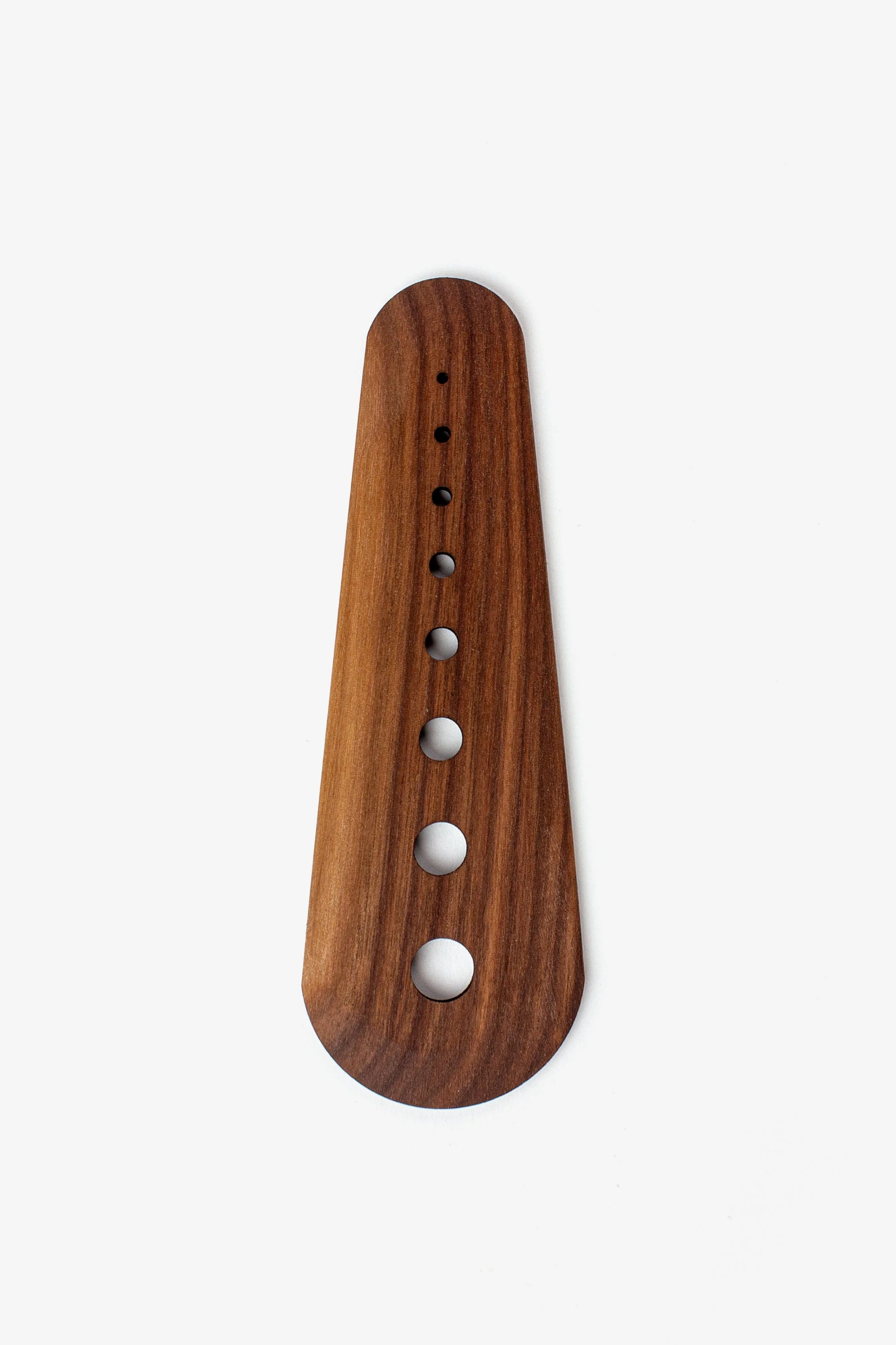 Wooden herb stripper with holes on a white background