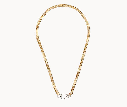 Gold chain necklace with a silver clasp on a white background