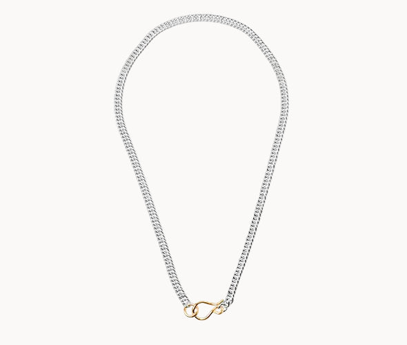 Silver chain necklace with a gold clasp on a white background